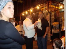 Zev speaking with man holding a chicken