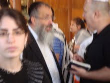 Zev speaking to another man